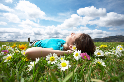 A woman laying in a field of flowers