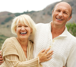 Middle-aged couple outdoors - for information on natural-looking dentures