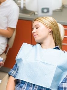 A woman asleep from dental sedation