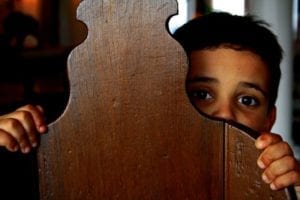 someone cowering behind a chair